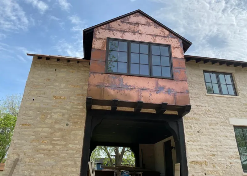 Copper metal panel facade on a stone building for Skylight Installation in Northridge